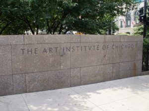 A stone wall with writing on it saying The Art Institute of Chicago