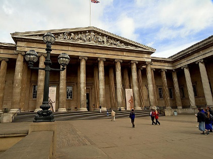 British Museum with columns and a flagDescription automatically generated