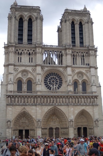 A large cathedral with two towers with Notre Dame de Paris in the backgroundDescription automatically generated