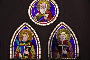 Stained glass windows with religious imagesDescription automatically generated