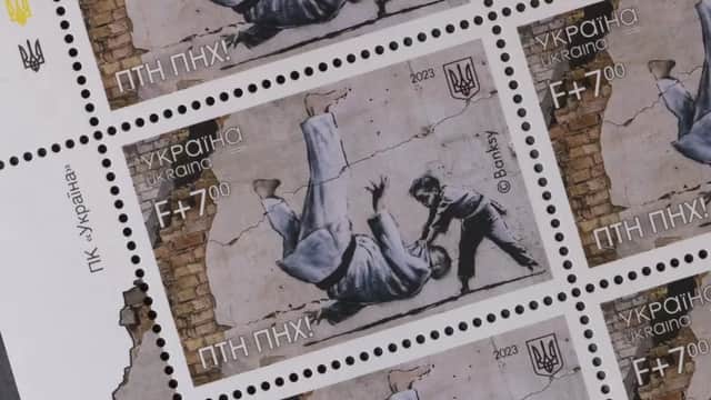 a stamp with a Banksy i mage on it