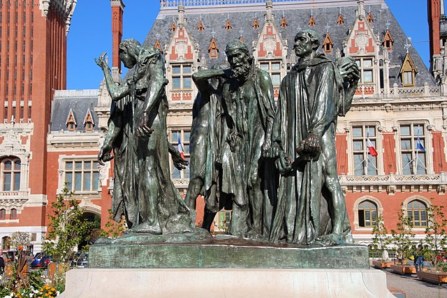 A group of statues in front of a buildingDescription automatically generated